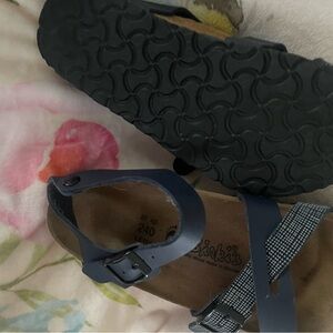 Birkenstock sandal with strap around foot